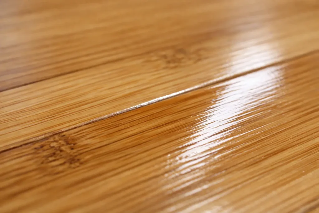 Close-up of bamboo flooring showing the glossy polyurethane finish layer